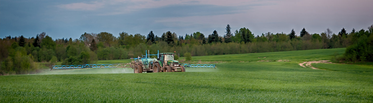 Tractor spraying field