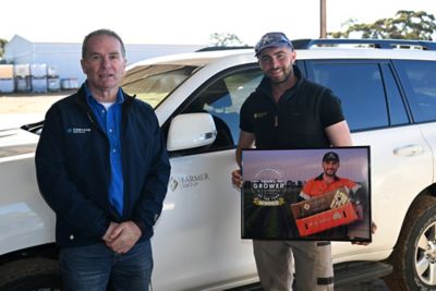Nick Weckert presents Luca Farmer with a commemorative gift in recognition of being named the 2026 Corteva Agriscience Young Grower of the Year.