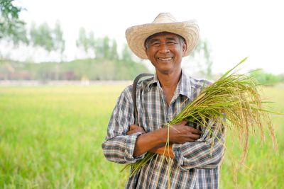 man in field holding grain