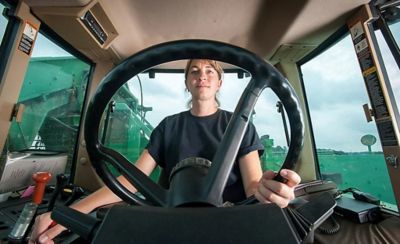 woman at steering wheel of tractor