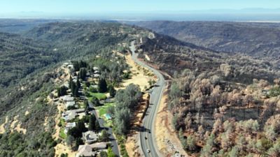 Burned out landscape (right) leading up to the shaded fuel break. Vegetation to the left of the highway was spared.