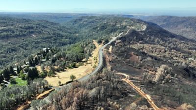 Widespread fire damage can be seen on the right, compared to the area protected by the shaded fuel break on the left.
