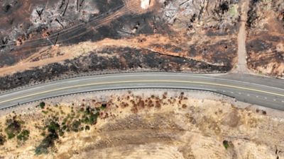 Overhead view of Highway 32 showing clear delineation where the fire was stopped by the shaded fuel break across the road.
