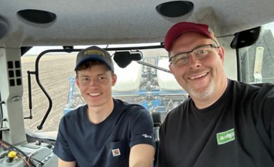 Bill Belzer and Son Jacob in Cab of Tractor