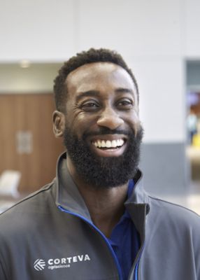 man smiling wearing Corteva logo jacket