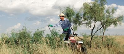 Man spraying DuraCor from an ATV
