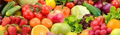 Colorful assortment of fresh fruits and vegetables, including apples, oranges, strawberries, grapes, tomatoes, cucumbers, peppers, cabbage, onions and leafy lettuce.
