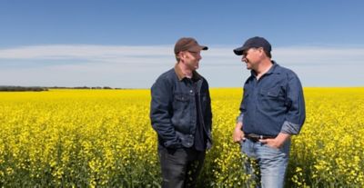 two men in field talking