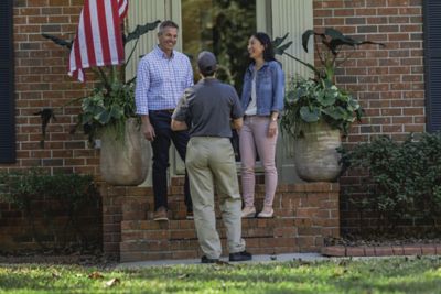 Certified Sentricon Specialist greets homeowners on front porch
