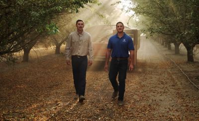 Man and sales rep walking on dirt road