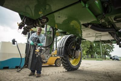 Farmer connecting Enlist bulk tank to sprayer 