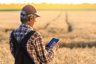 Farmer with a mobile on field