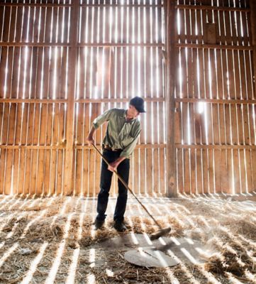 farmer sweeping barn