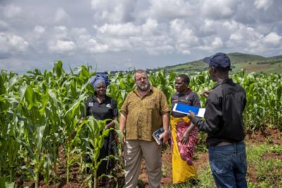 two men and two women in corn field discussing