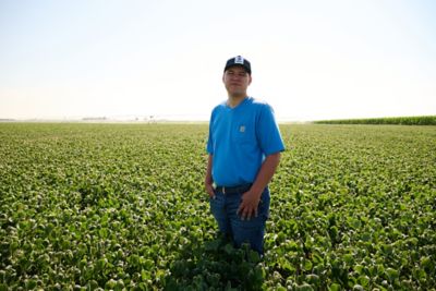 farmer standing in soybean field