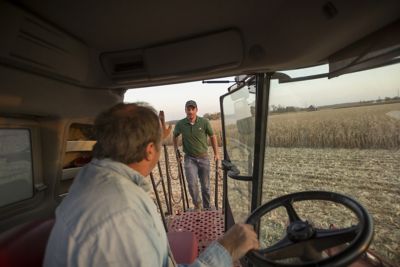 Photo - grower in harvester cab - waving to Pioneer rep