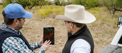 A CLC and rancher reviewing the LandVisor app