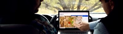 Two men sitting in a truck reviewing LandVisor insights