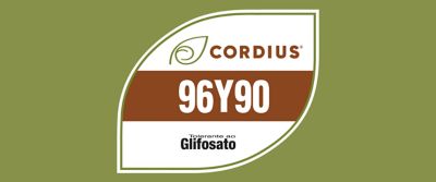 A imagem mostra um selo em formato de folha sobre fundo verde-oliva. Dentro do selo aparece a marca Cordius® com um ícone de folha, seguida pelo código “96Y90” em destaque sobre uma faixa marrom. Na parte inferior, há o logotipo “Tolerante ao Glifosato”, indicando a tecnologia associada à cultivar.
