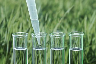 precision micropipette transferring liquid into a test tube