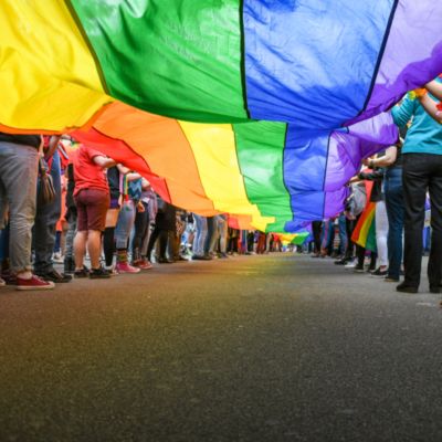 People holding rainbow pride flag