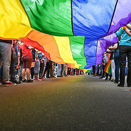 People holding rainbow pride flag