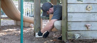 Sentricon specialist installing Recruit AG station at playground