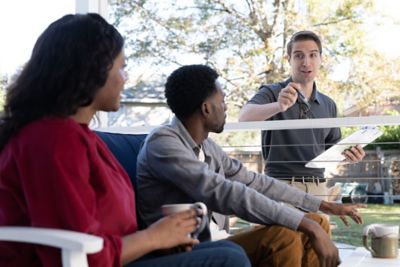 Sentricon specialist talking with homeowners on back porch