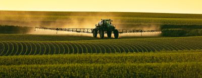 Sprayer in field at sunset