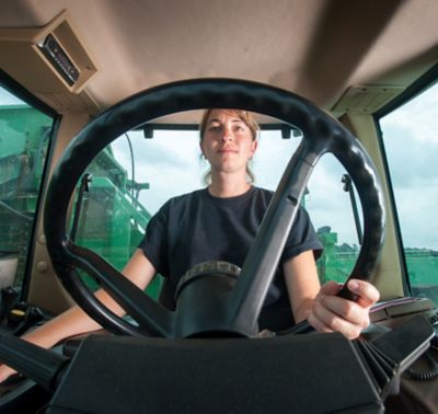 woman farmer driving tractor - internal view
