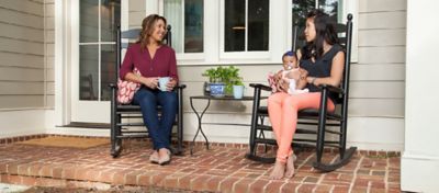 Two women in rocking chairs on the porch