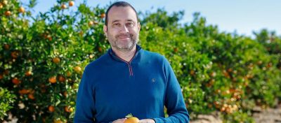Farmer-Smiling-With-Tangerine