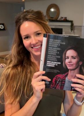 A woman farmer who is smiling, to convey how Corteva supports women in farming.