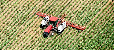 Aerial view of red tractor sprayer in field