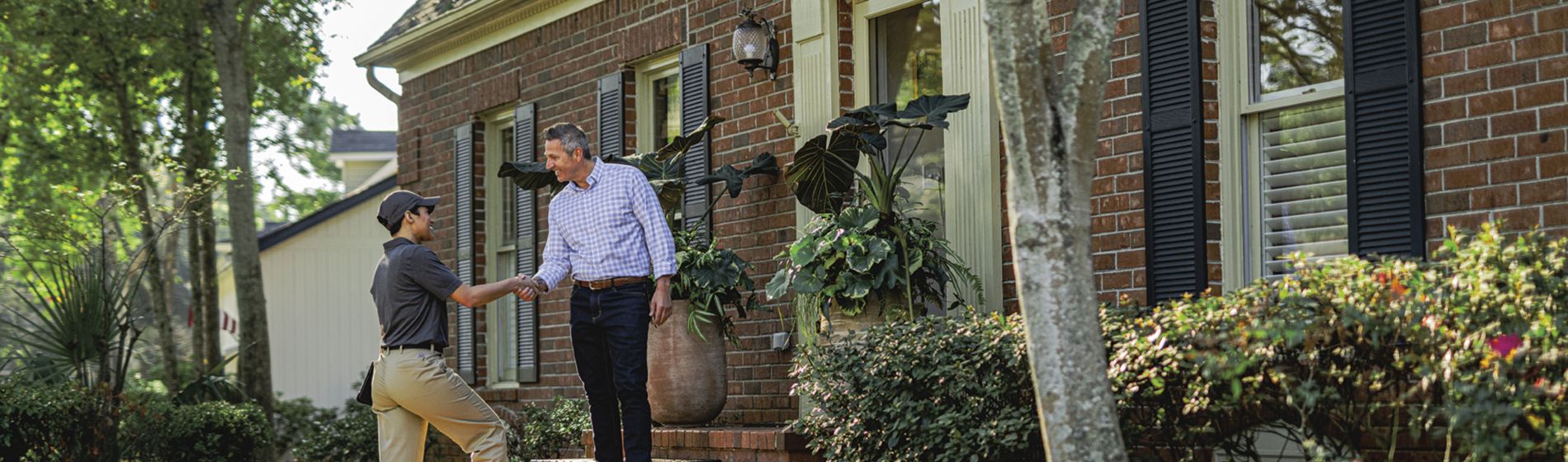 Homeowner talking with Sentricon Certified Specialist on front step