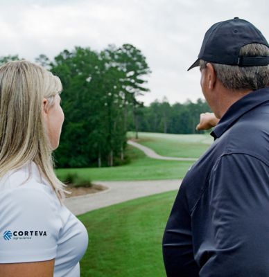 Corteva rep talking with golf superintendent on the course