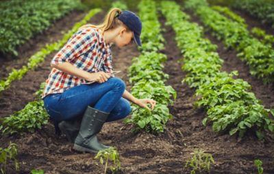 woman crouching in a field