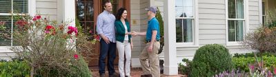 A certified Sentricon specialist shaking hands with a homeowner