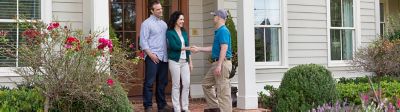 A certified Sentricon specialist shaking hands with a homeowner