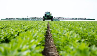 Sprayer in soybeans, front view, horizon