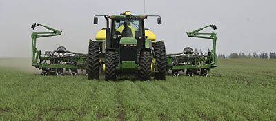 Green tractor planting cover crops