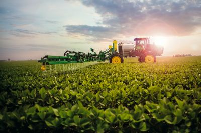 Sideview from horizon at sunrise sprayer in early soybeans