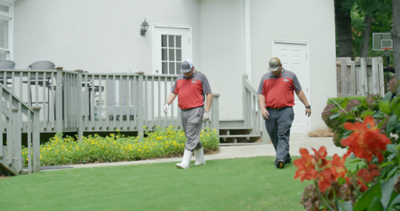 Landscape professionals walking in backyard