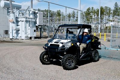Worker on ATV spraying bare ground