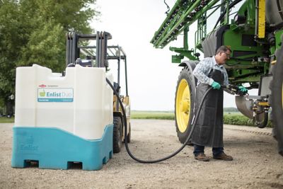 man filling sprayer with Enlist Duo