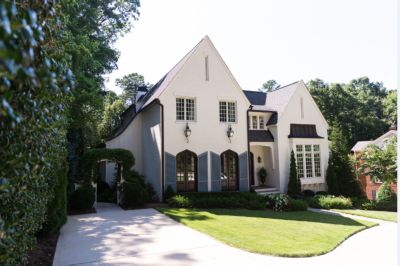 White brick house with manicured lawn