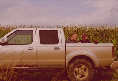 Two men talking at a truck bed