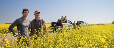two men in canola field