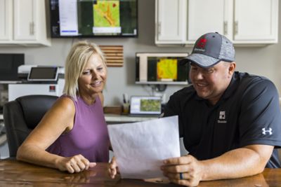 Rep and farmer looking at field imagery