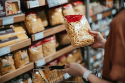 selecting pasta and a grocery store